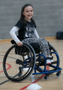 Girl in wheelchair in gym - Children’s Seats and Harnesses